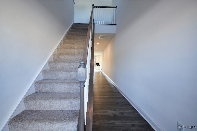 staircase with hardwood / wood-style flooring