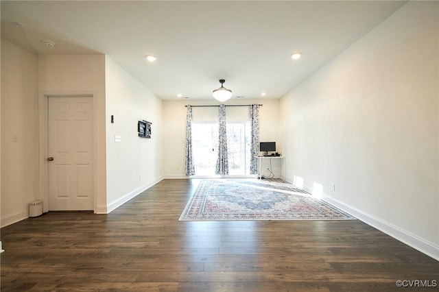 unfurnished living room featuring dark wood-type flooring