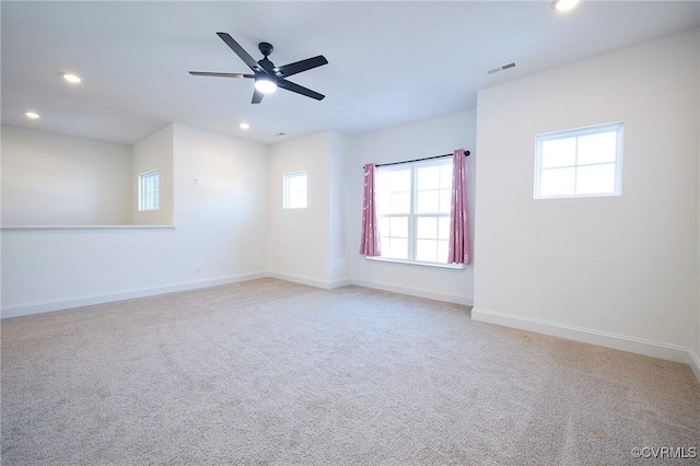 carpeted empty room featuring ceiling fan