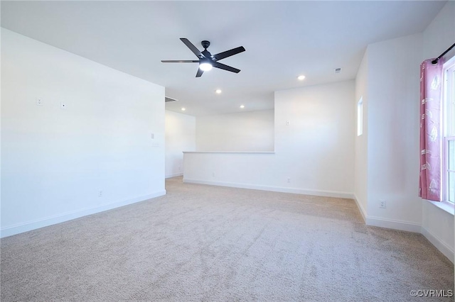 carpeted spare room with ceiling fan