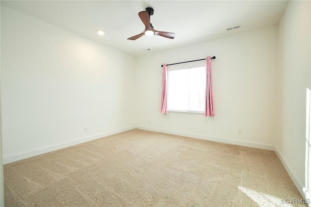 empty room featuring ceiling fan and carpet floors