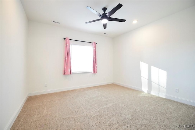 carpeted spare room featuring ceiling fan