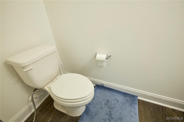 bathroom with hardwood / wood-style flooring and toilet