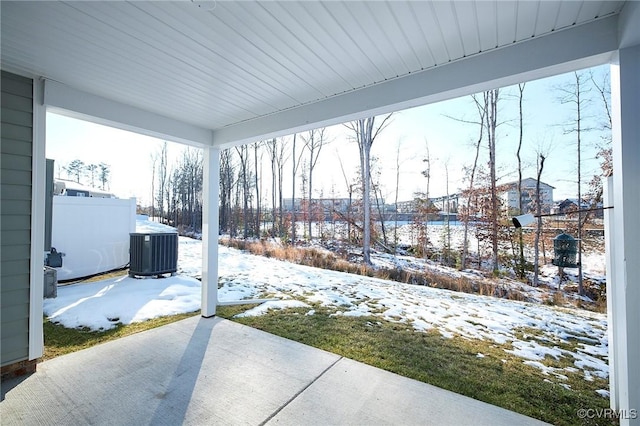 snow covered patio with central air condition unit