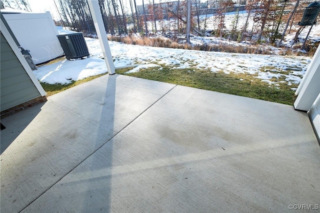 snow covered patio with cooling unit