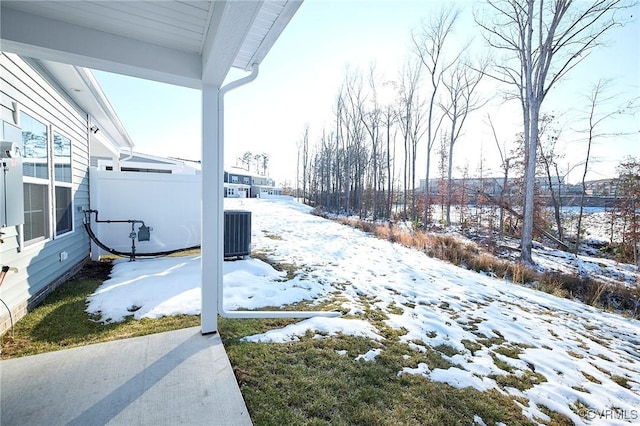 yard covered in snow featuring cooling unit