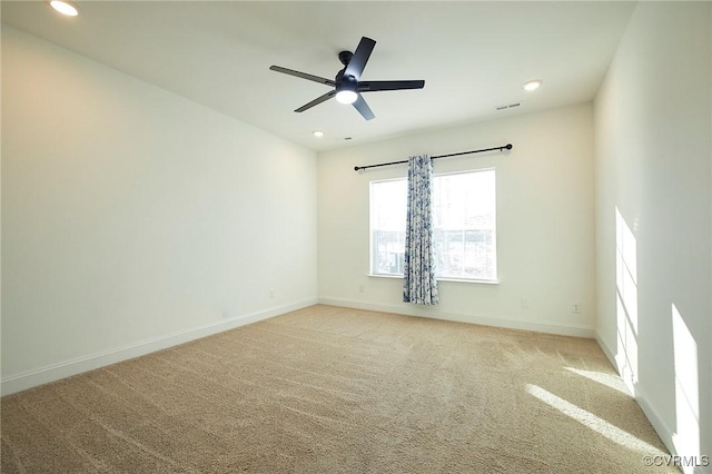 unfurnished room featuring light carpet and ceiling fan