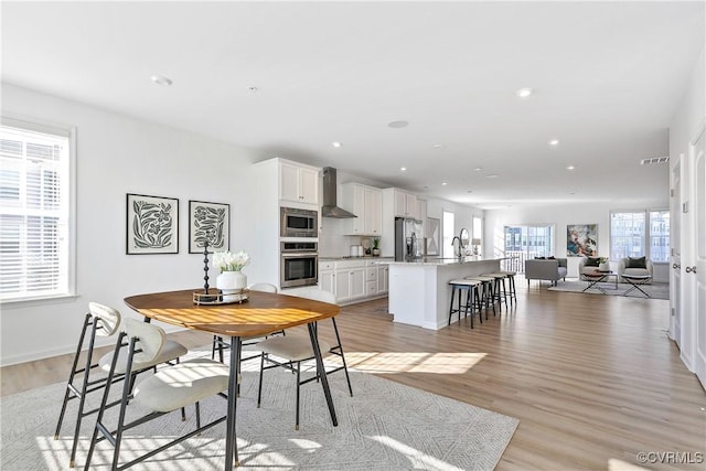 dining area featuring light hardwood / wood-style flooring and sink