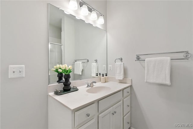 bathroom with vanity and a shower with shower door