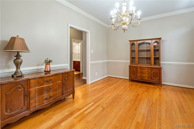 interior space featuring crown molding, a chandelier, and light hardwood / wood-style flooring