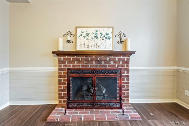 room details featuring hardwood / wood-style floors and a brick fireplace