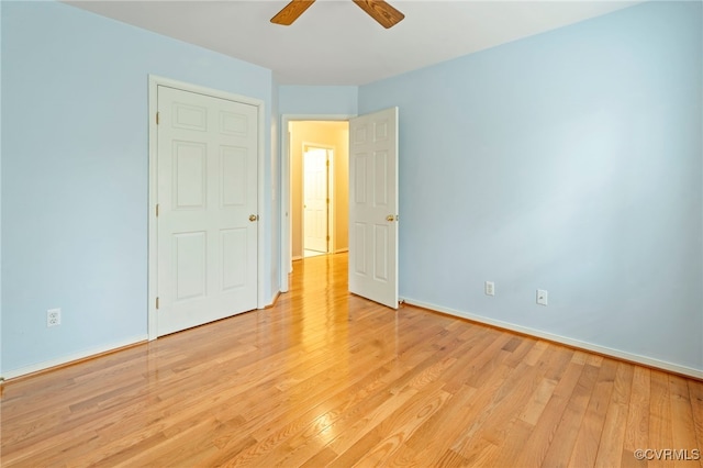 unfurnished bedroom with ceiling fan and light wood-type flooring