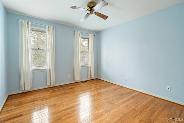 spare room with ceiling fan and light wood-type flooring