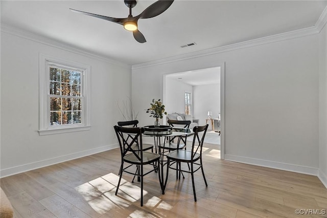 dining room with ceiling fan, light hardwood / wood-style floors, and ornamental molding