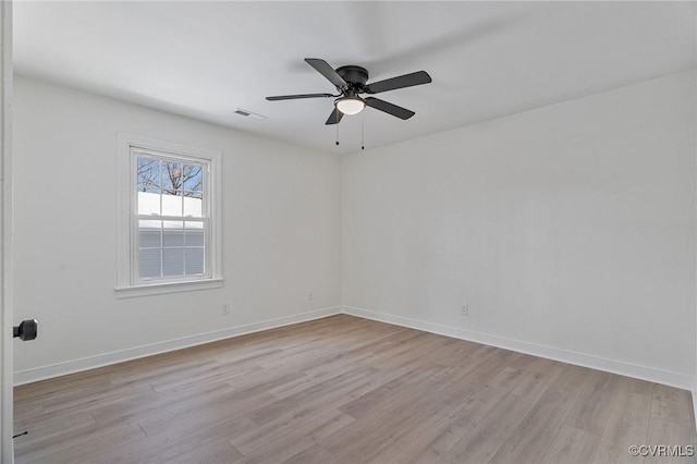 spare room with light wood-type flooring and ceiling fan