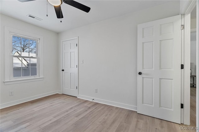 spare room with ceiling fan and light wood-type flooring