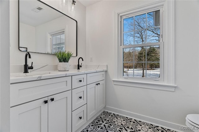 bathroom with tile patterned floors and vanity