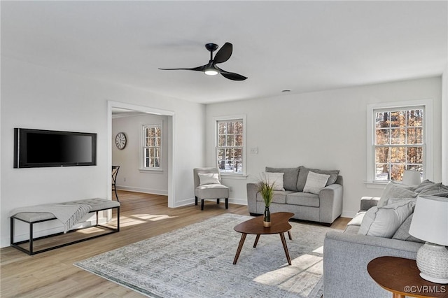 living room featuring light wood-type flooring and ceiling fan