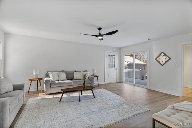 living room featuring ceiling fan and light hardwood / wood-style flooring