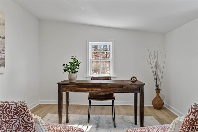 office featuring vaulted ceiling and light hardwood / wood-style flooring