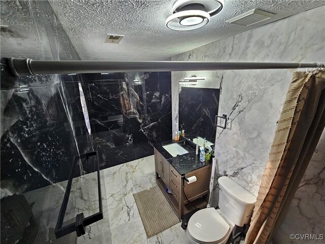 bathroom featuring vanity, toilet, tile walls, and a shower with door