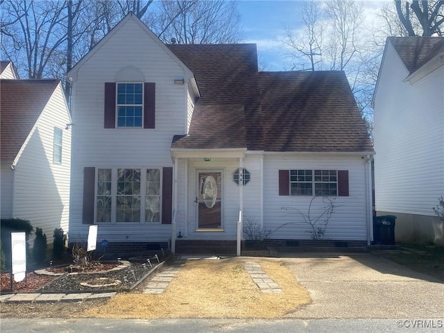 traditional-style house with a shingled roof and crawl space