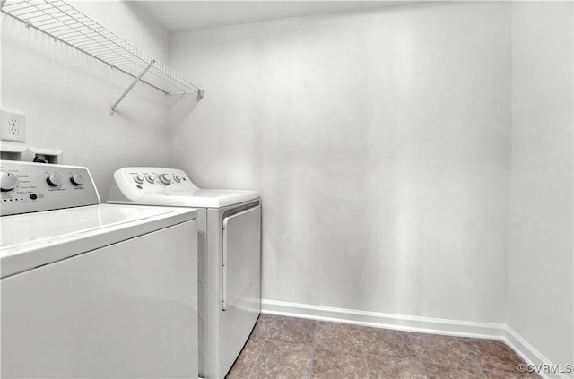 clothes washing area with washing machine and clothes dryer