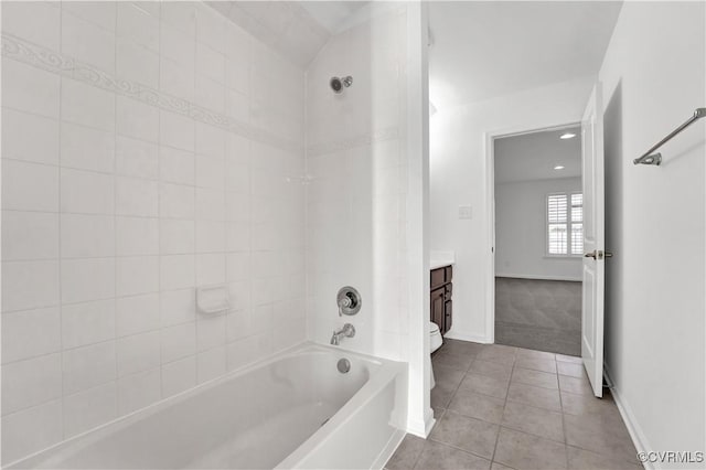 full bathroom with toilet, vanity, tile patterned flooring, and tiled shower / bath