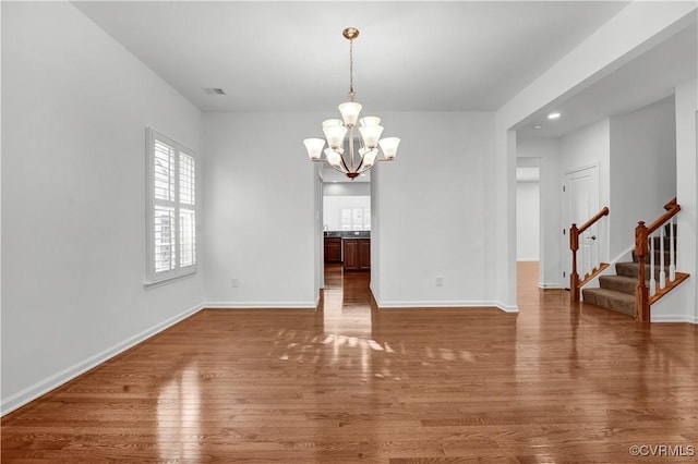 dining space with a notable chandelier and dark hardwood / wood-style floors