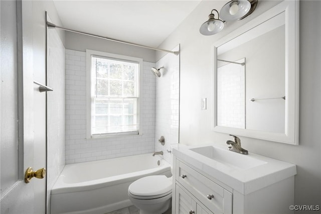 full bathroom featuring toilet, tiled shower / bath, and vanity