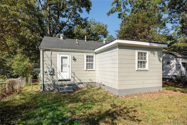 rear view of property with a yard