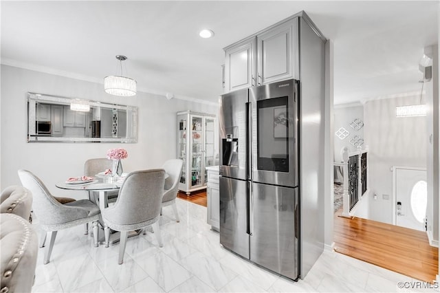 kitchen featuring stainless steel appliances, crown molding, gray cabinetry, and hanging light fixtures