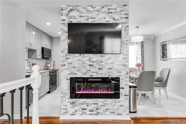 kitchen with ornamental molding, electric range, and gray cabinetry