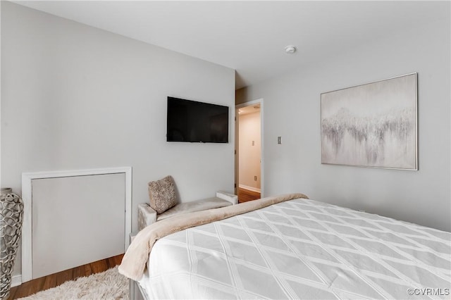 bedroom with a closet and hardwood / wood-style floors