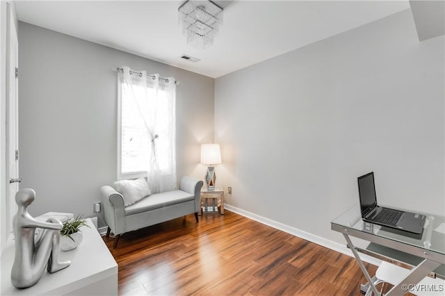 sitting room with dark wood-type flooring