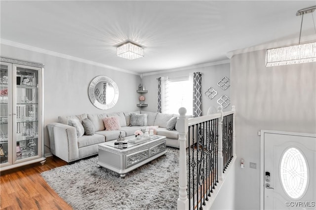 living room with hardwood / wood-style flooring and crown molding