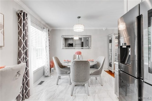 dining space featuring ornamental molding