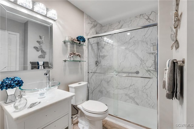 bathroom with walk in shower, vanity, and toilet