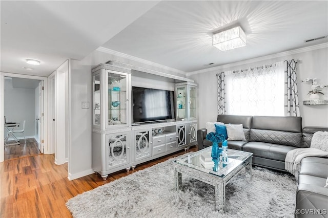 living room with wood-type flooring and ornamental molding