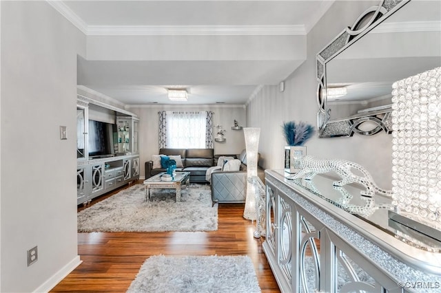 living room with wood-type flooring and ornamental molding