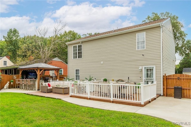 back of property featuring a lawn, outdoor lounge area, a patio area, and a gazebo