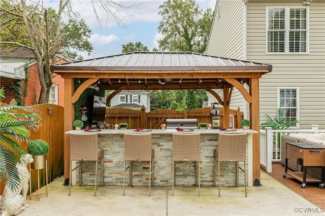 view of patio / terrace with a gazebo, grilling area, and exterior bar