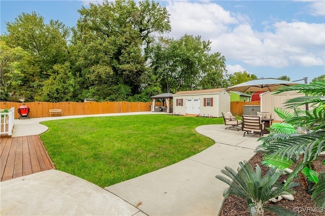 view of yard featuring a patio and a storage shed