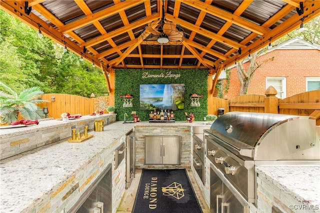 view of patio with a gazebo, an outdoor kitchen, and area for grilling