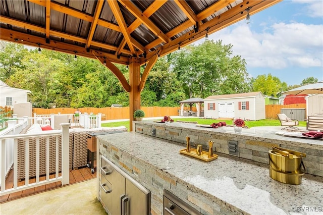 view of patio featuring an outdoor structure and a gazebo