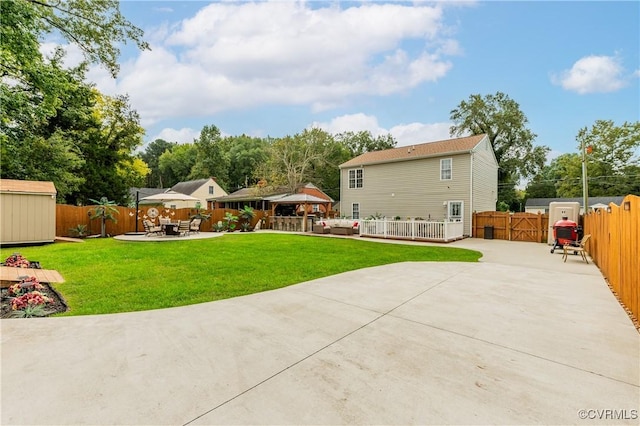 rear view of house featuring an outdoor hangout area, a patio area, a yard, a storage shed, and a gazebo