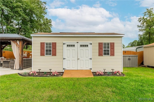 view of outbuilding with a yard