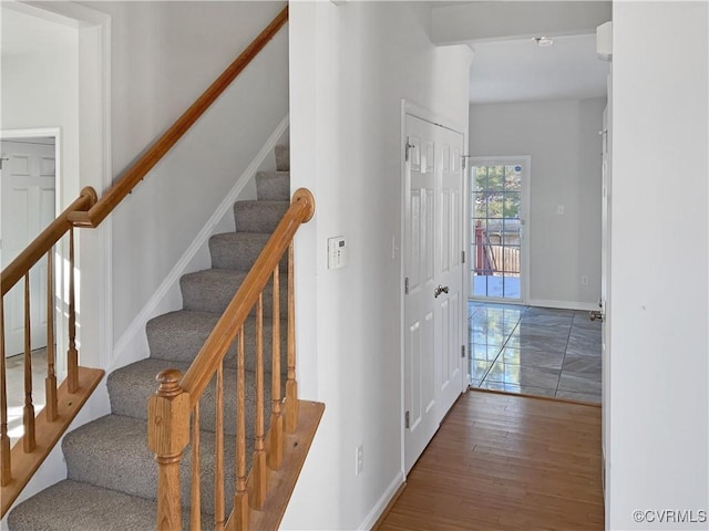 staircase featuring hardwood / wood-style flooring