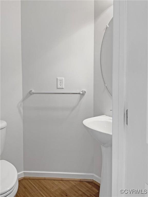 bathroom featuring toilet and hardwood / wood-style flooring