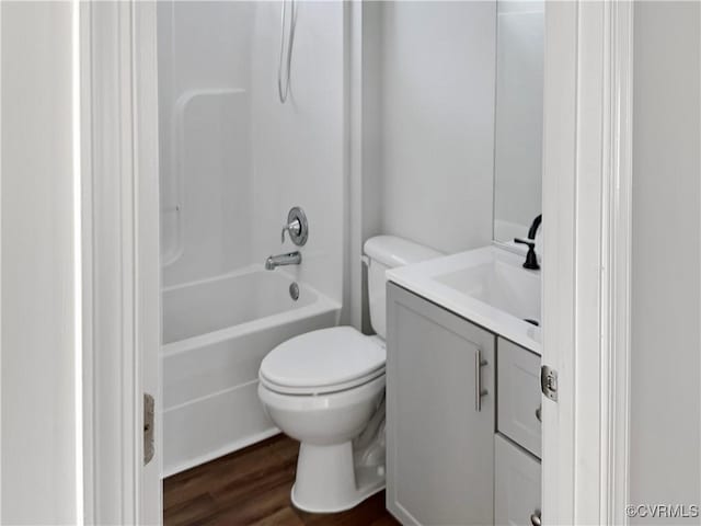 full bathroom featuring shower / tub combination, hardwood / wood-style floors, vanity, and toilet